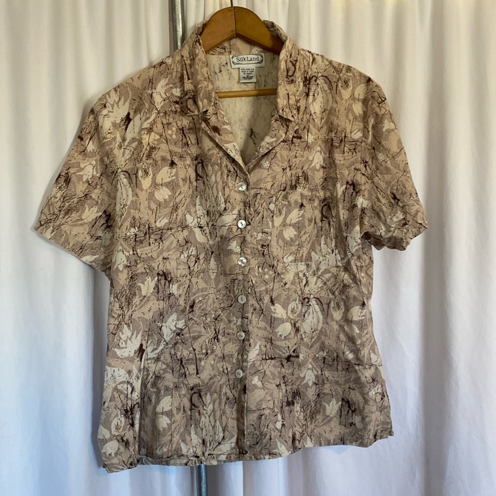 Tan short sleeved button up blouse.